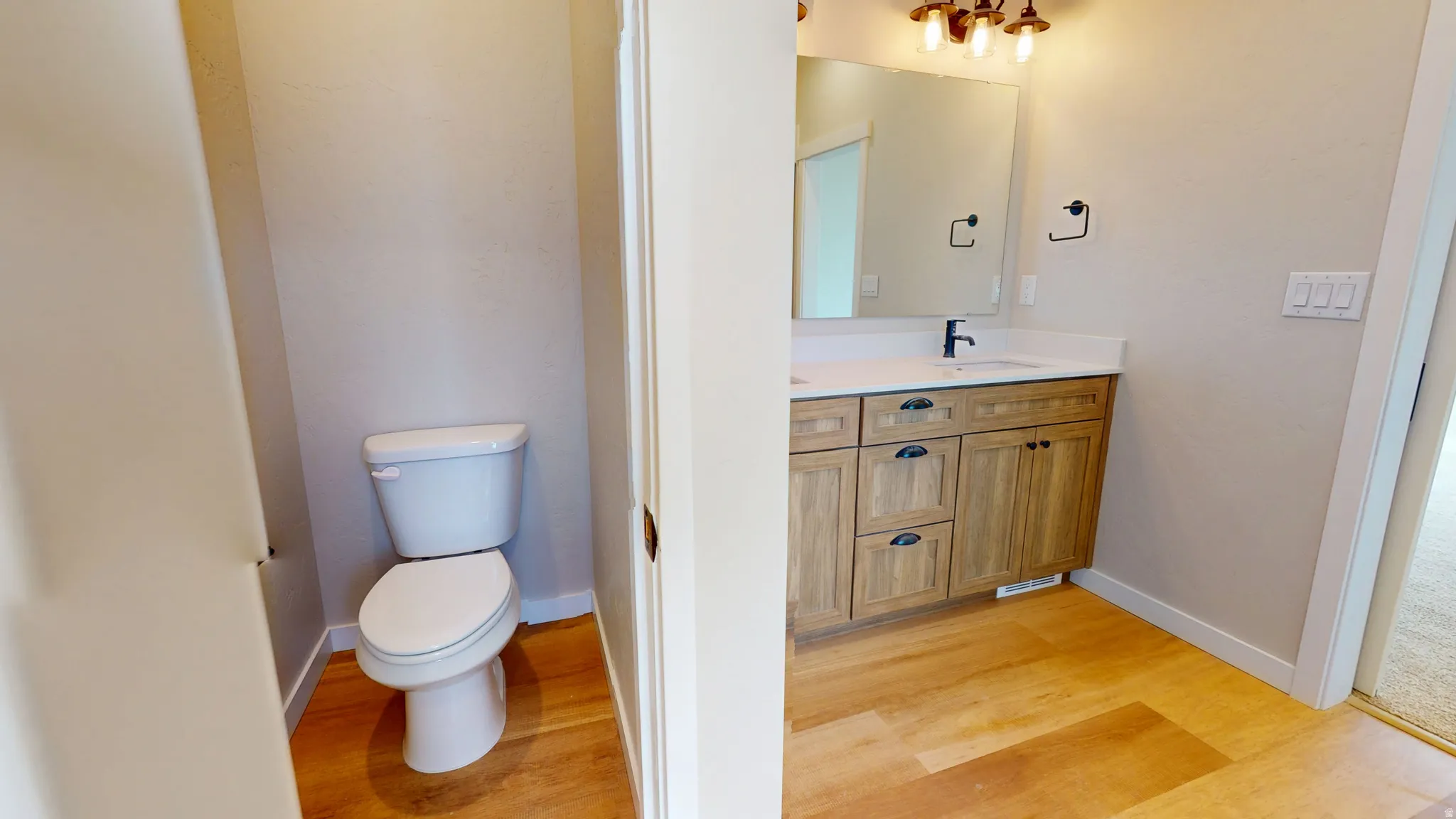 Bathroom with vanity and light wood-style flooring