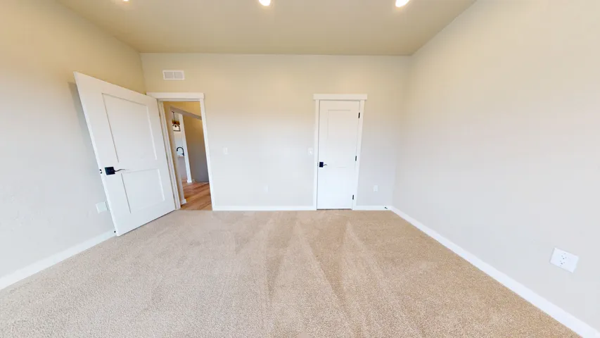 Unfurnished bedroom with carpet and recessed lighting