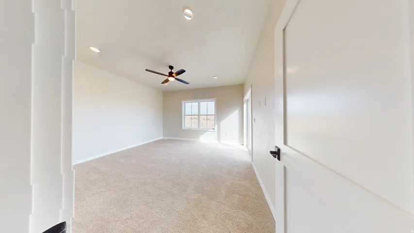 Empty room featuring light carpet, recessed lighting, and ceiling fan