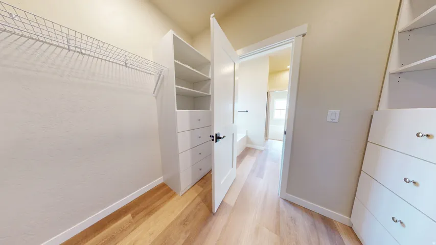 Spacious closet with light wood-style floors