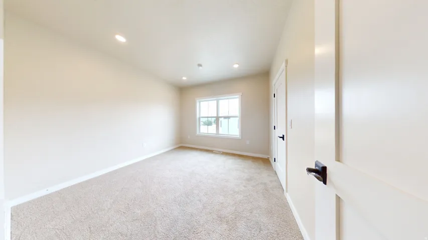 Unfurnished room featuring light colored carpet and recessed lighting