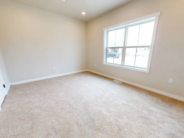 Unfurnished bedroom featuring light carpet, recessed lighting, and a closet