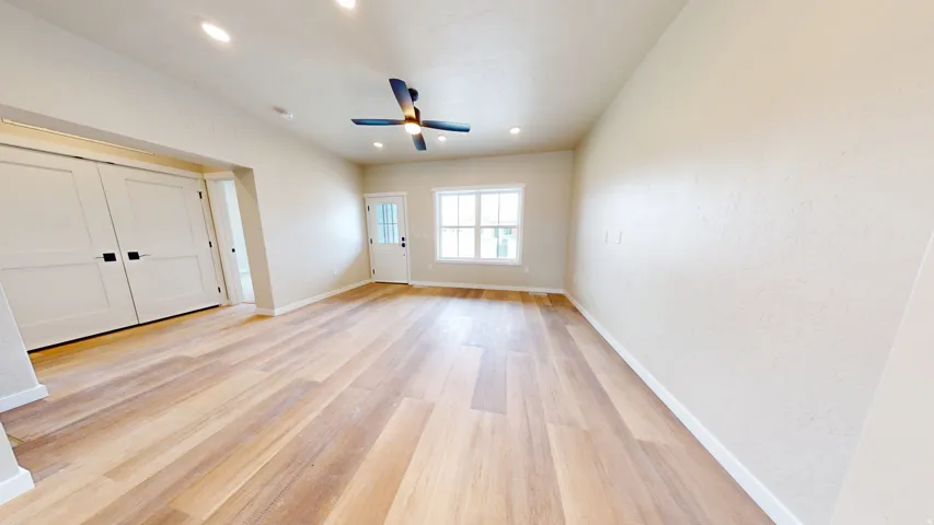 Empty room with light wood finished floors, recessed lighting, and ceiling fan