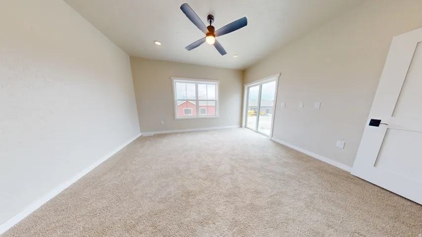 Carpeted spare room with ceiling fan and recessed lighting