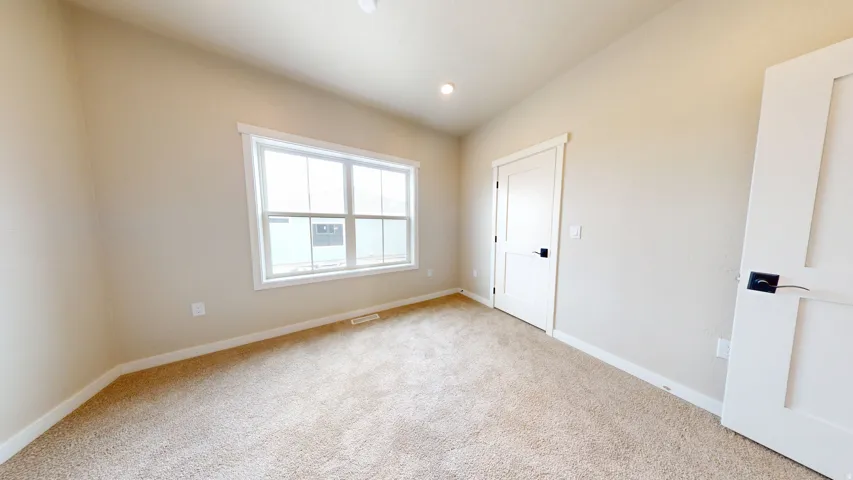 Unfurnished bedroom with carpet and recessed lighting