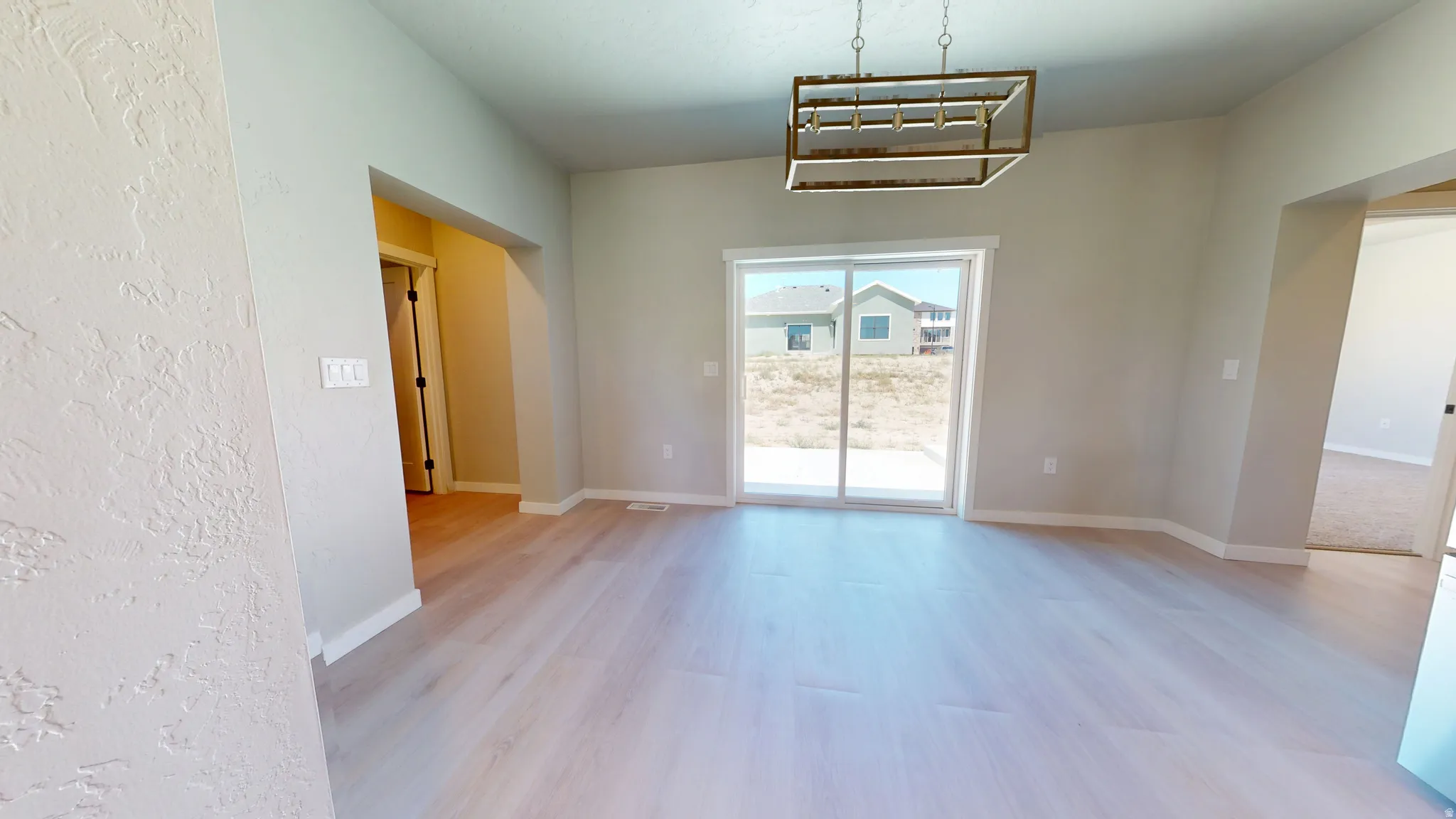 Unfurnished dining area featuring baseboards and light wood-style floors