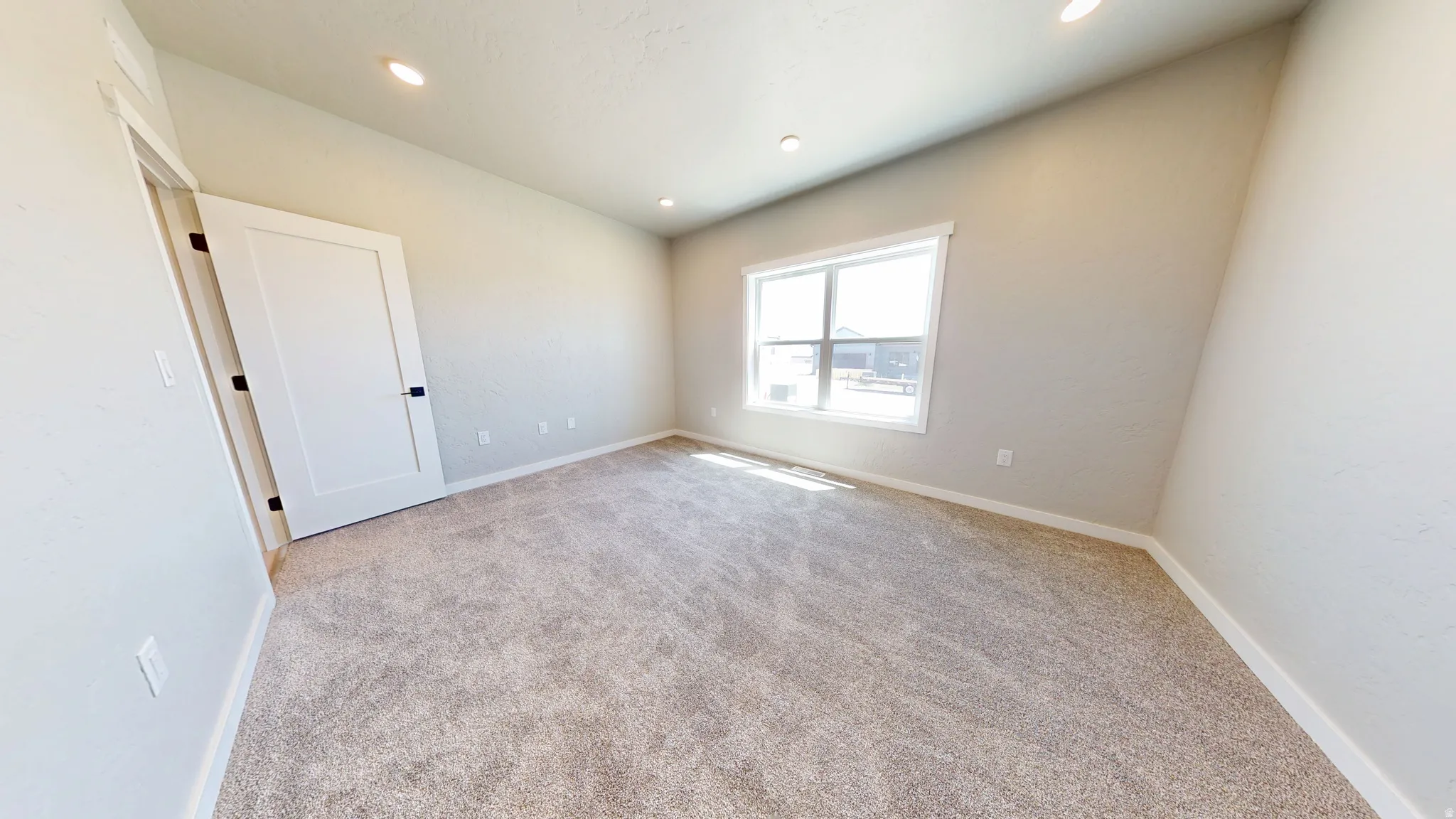 Unfurnished room featuring light colored carpet and recessed lighting