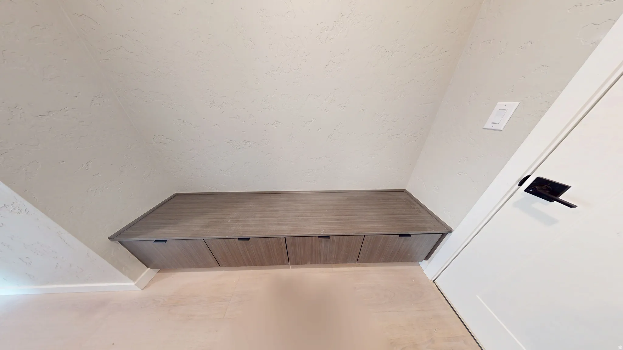 Detailed view of a textured wall and baseboards