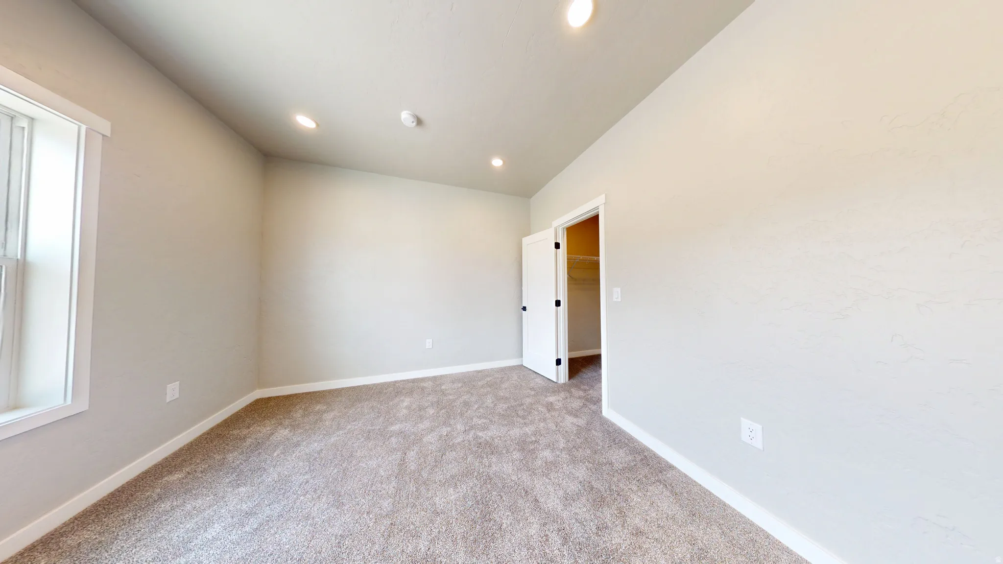 Unfurnished room featuring light carpet and recessed lighting