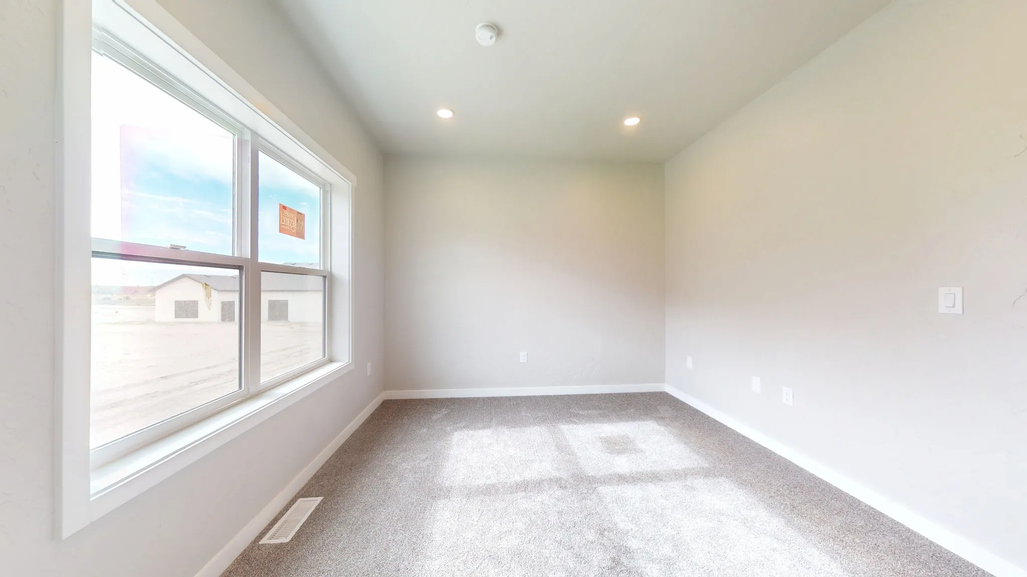 Empty room featuring light carpet and recessed lighting