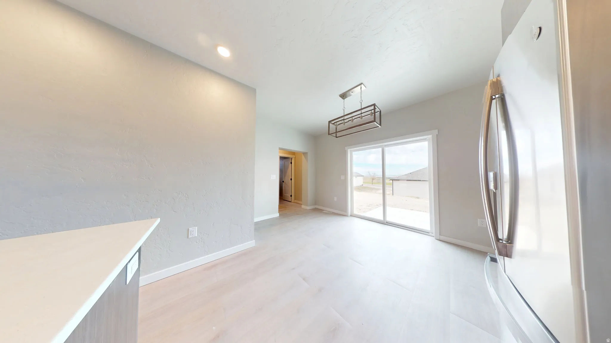 Unfurnished dining area with recessed lighting and light wood-style floors
