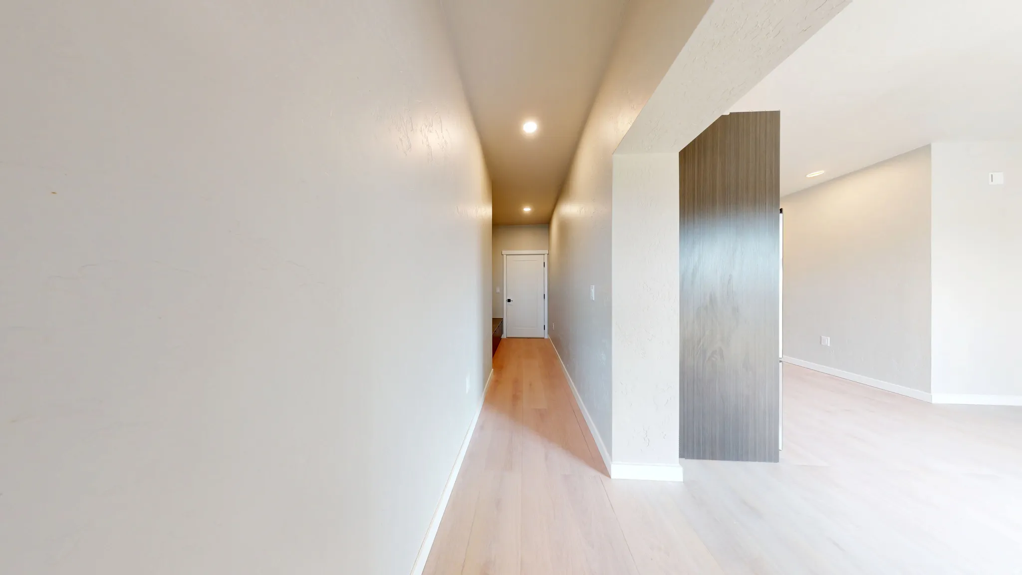 Hallway featuring light wood-style flooring and recessed lighting