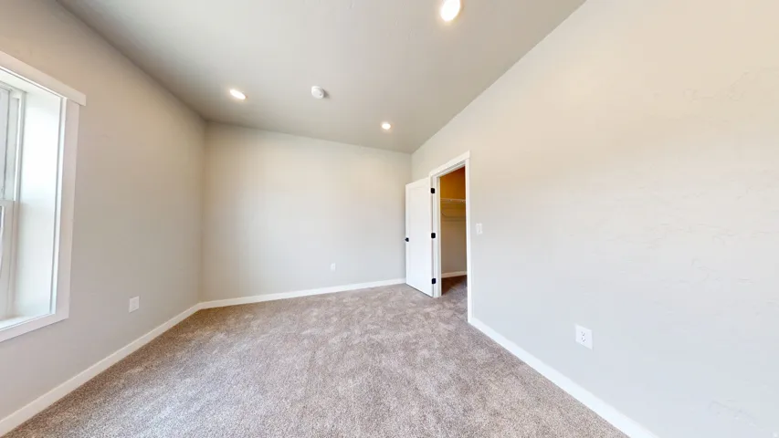 Unfurnished room featuring light carpet and recessed lighting