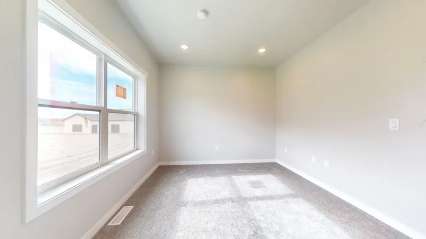 Empty room featuring light carpet and recessed lighting