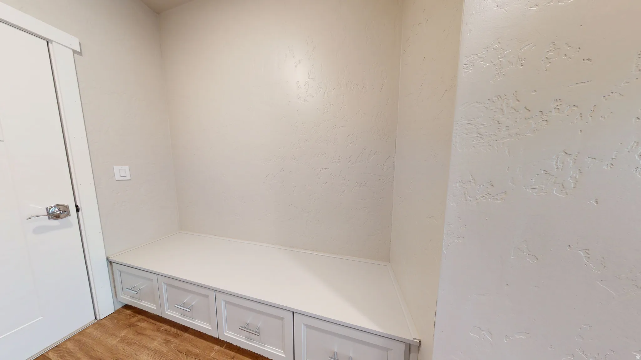 Mudroom featuring light wood finished floors