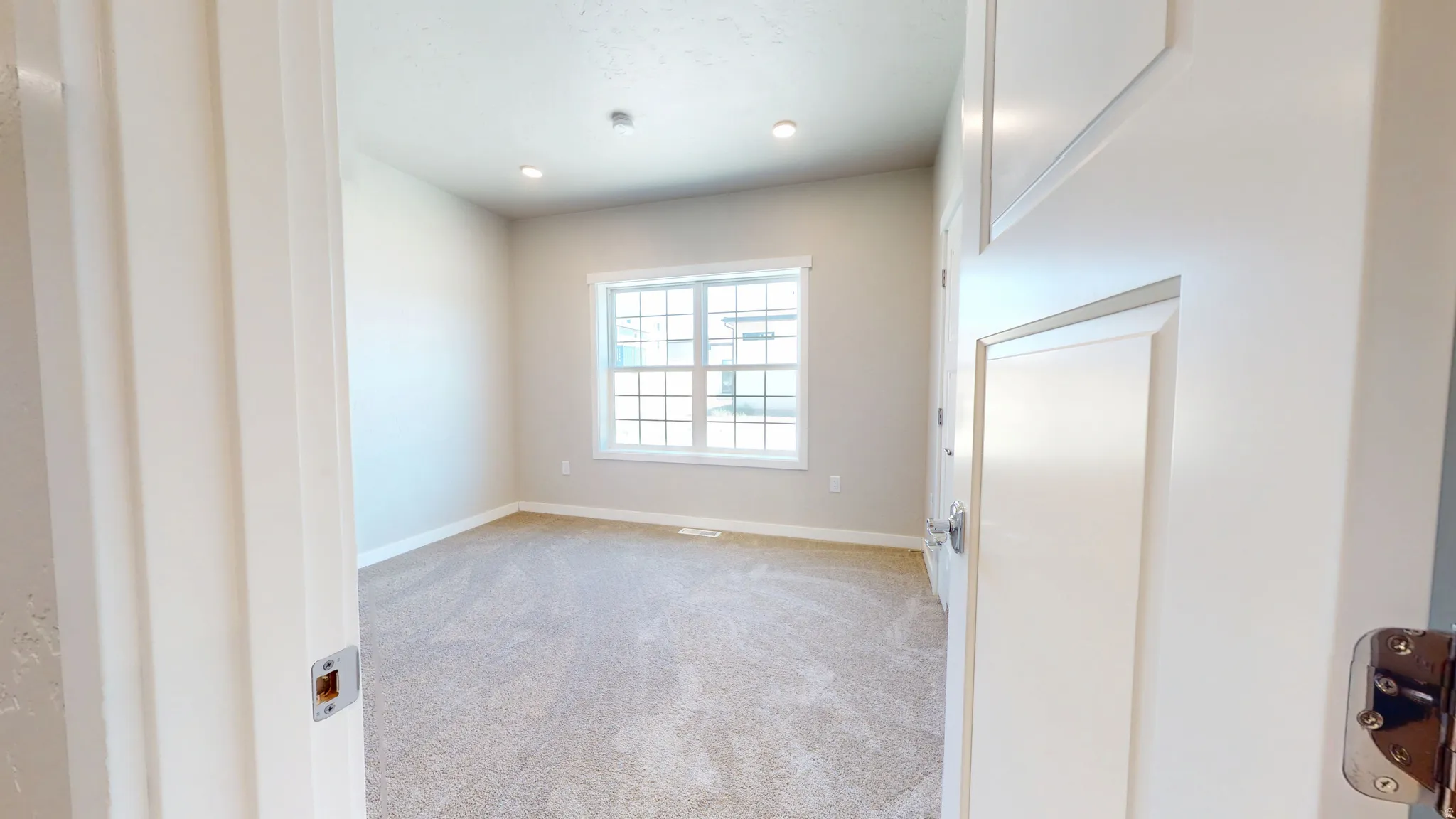 Spare room featuring light carpet and recessed lighting