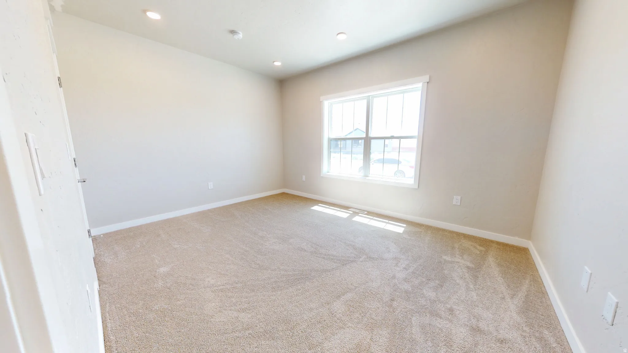 Unfurnished room featuring light colored carpet and recessed lighting