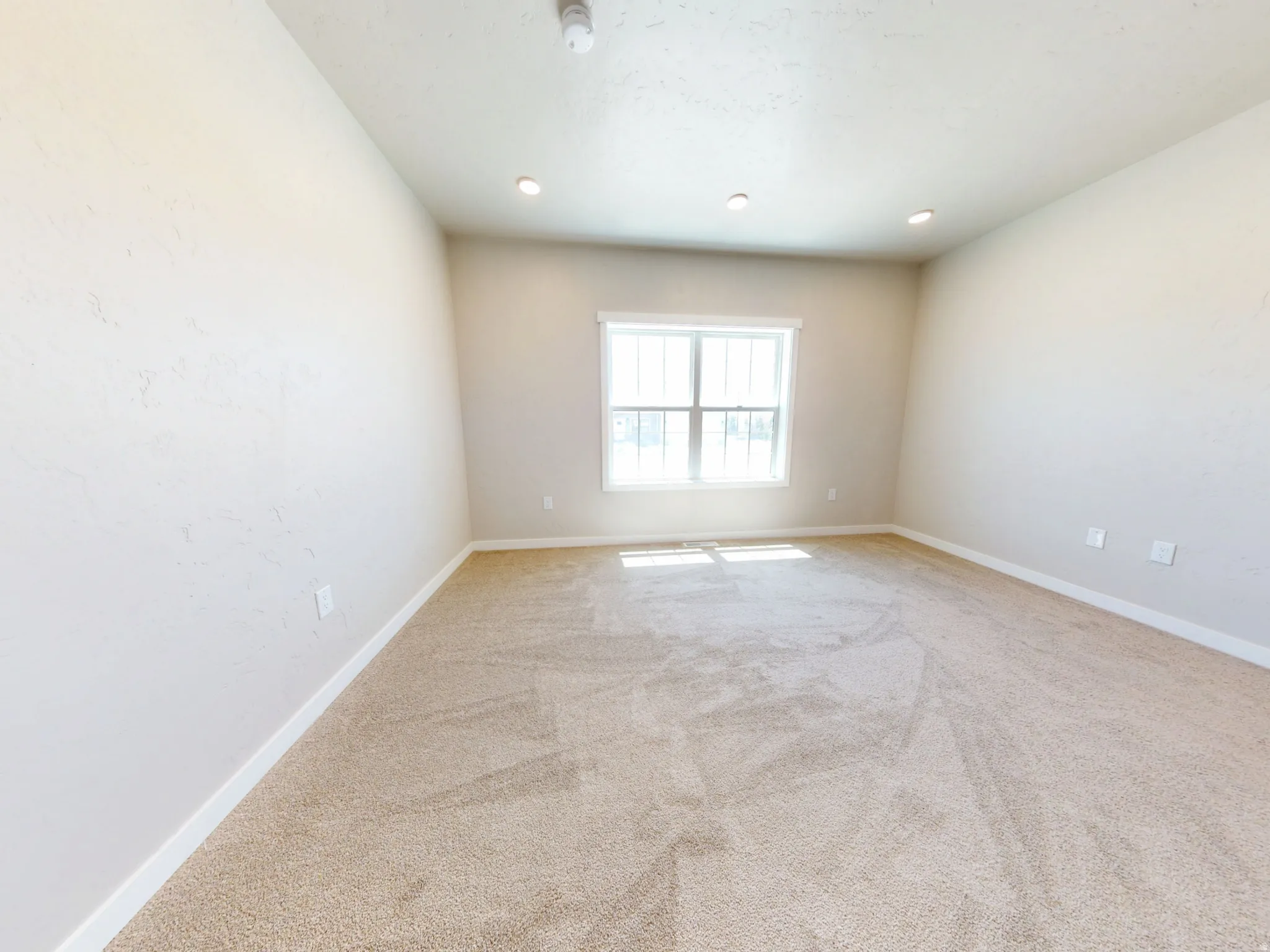 Empty room featuring light colored carpet and recessed lighting