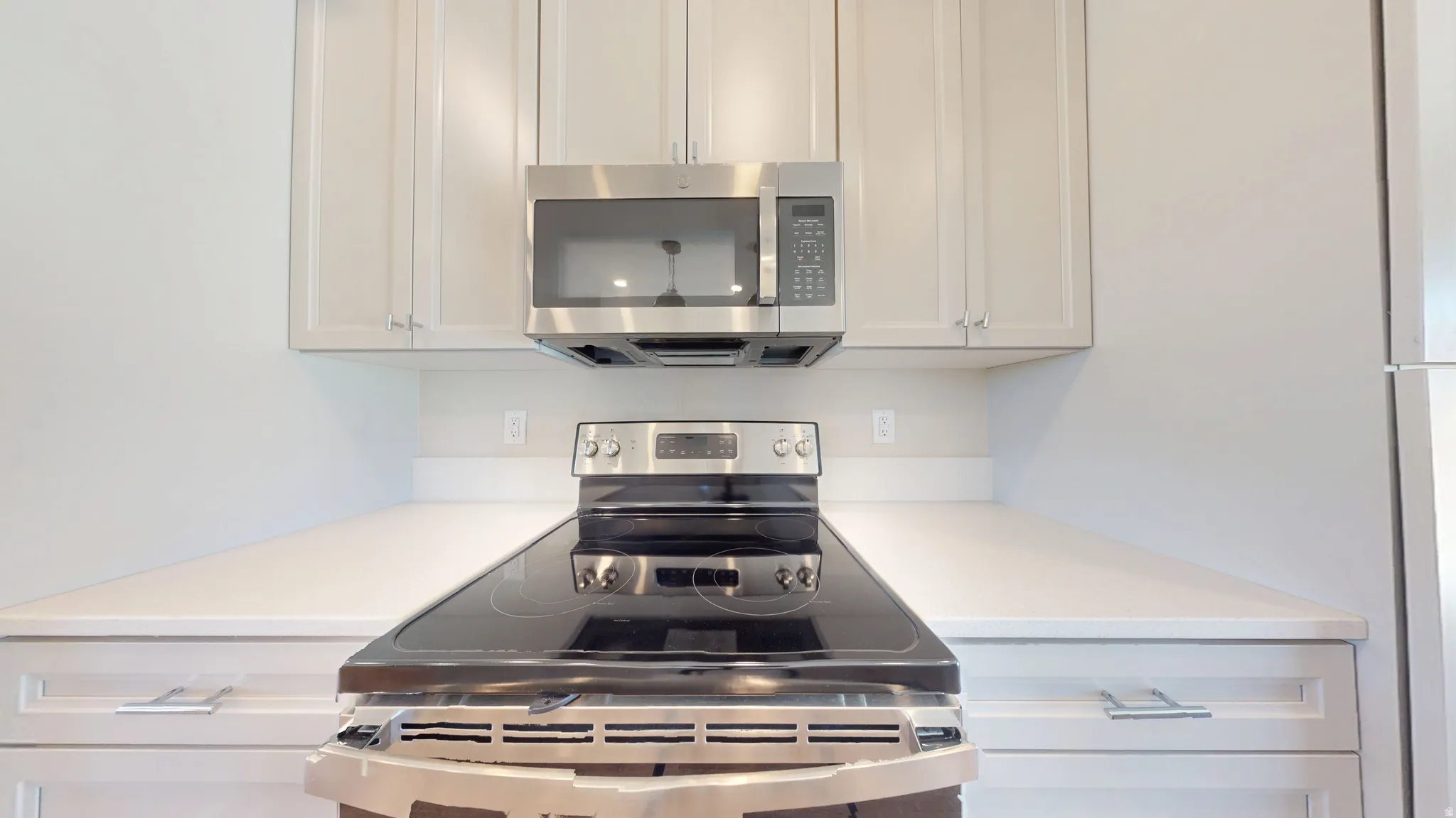 Kitchen with stainless steel appliances and white cabinets