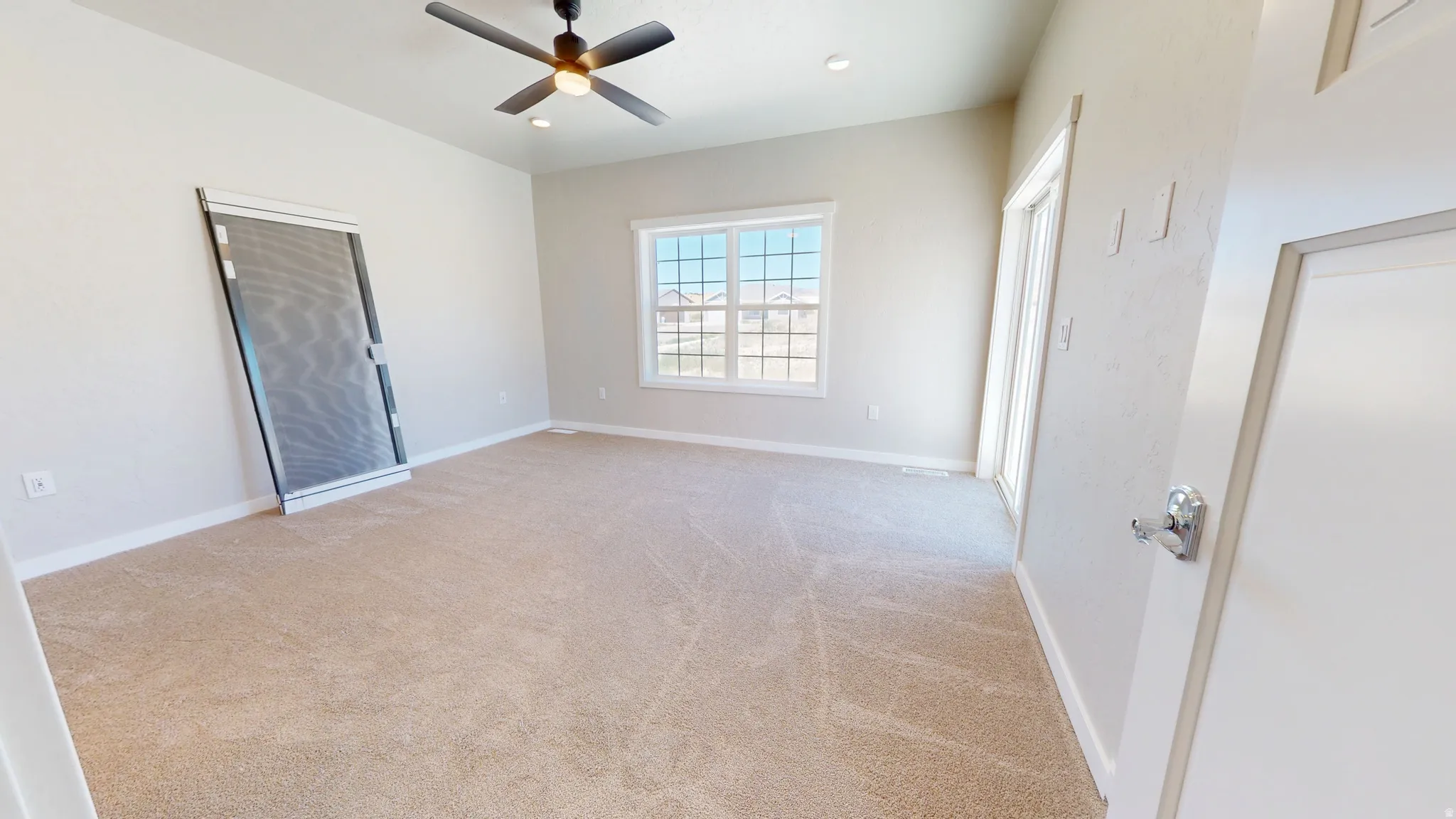 Unfurnished bedroom with light carpet, ceiling fan, and recessed lighting
