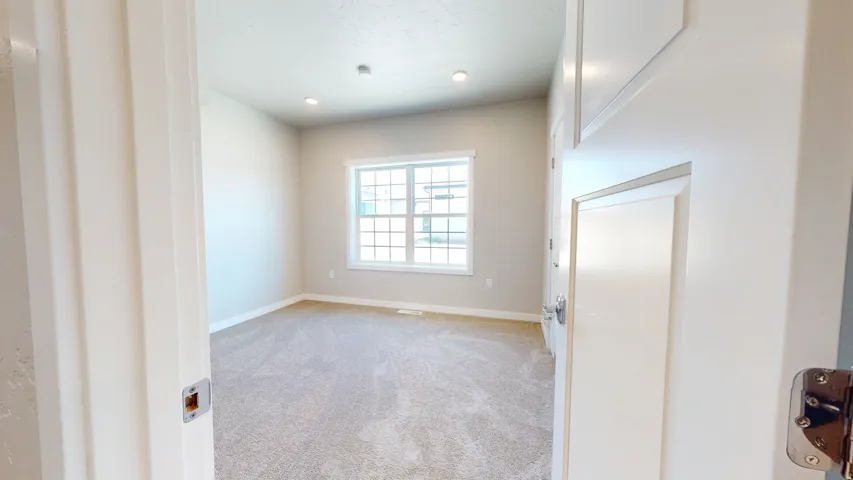 Spare room featuring light carpet and recessed lighting