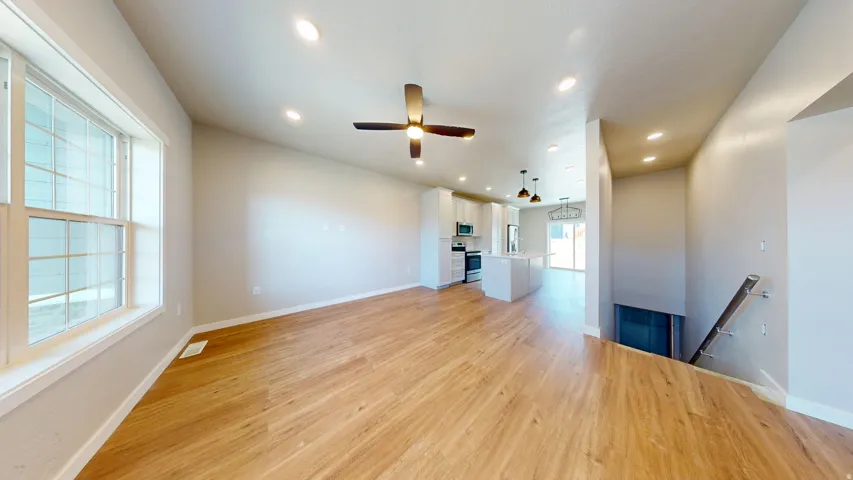 Unfurnished living room with light wood finished floors, recessed lighting, and a ceiling fan