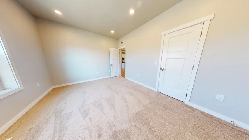 Unfurnished bedroom with carpet and recessed lighting