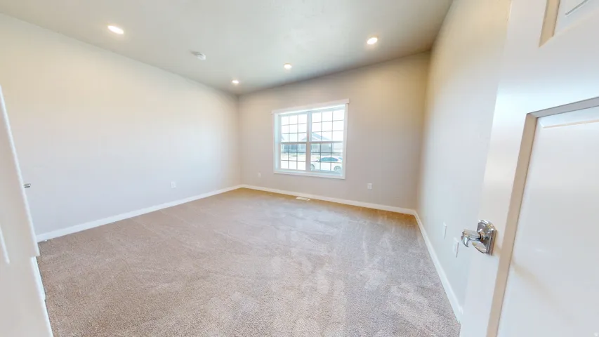 Unfurnished room with light colored carpet and recessed lighting