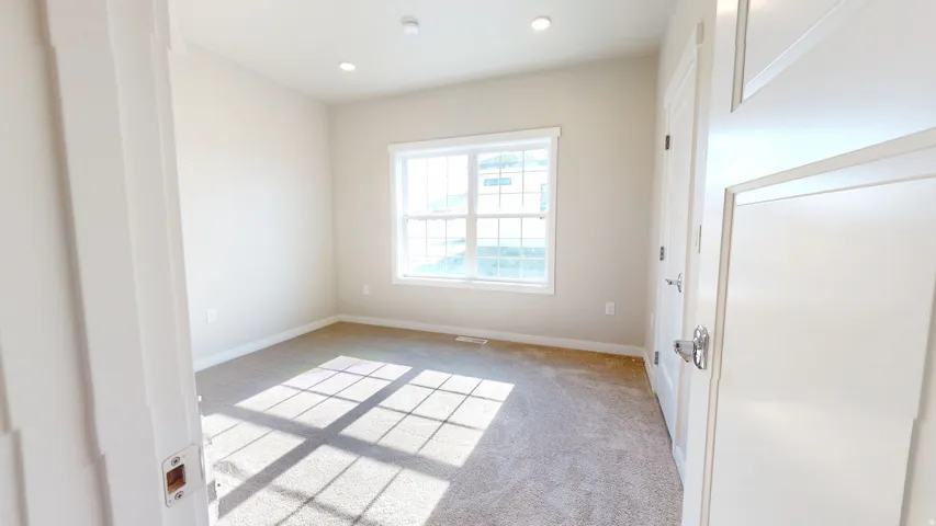Spare room with light carpet and recessed lighting