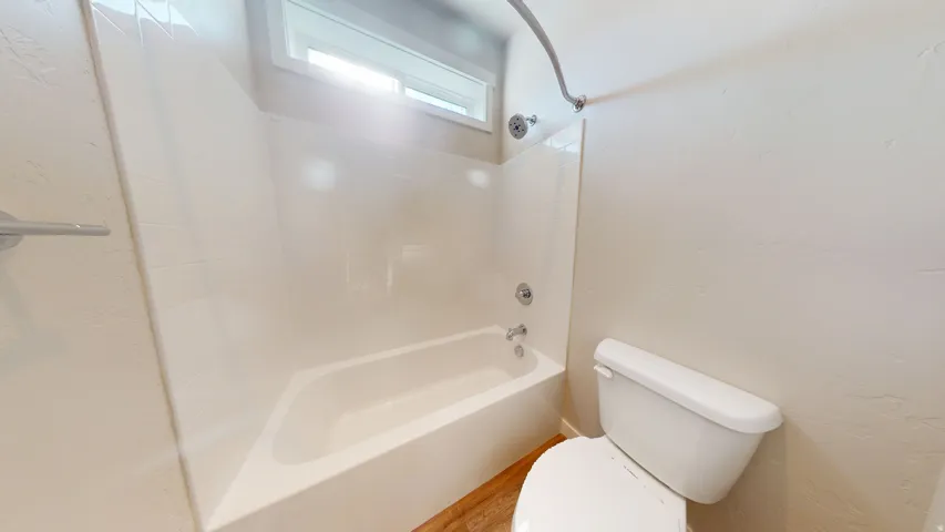 Bathroom featuring toilet and bathtub / shower combination