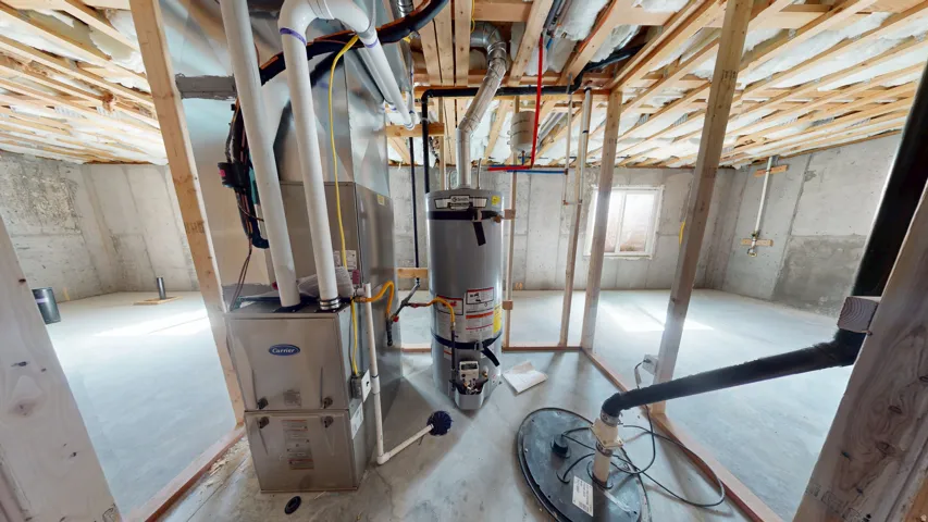 Unfinished below grade area featuring water heater and heating unit