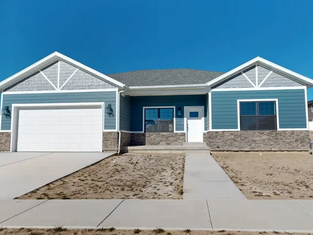 Craftsman-style house with covered porch, concrete driveway, stone siding, and an attached garage