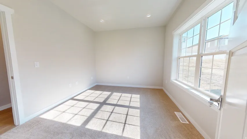 Unfurnished room featuring light carpet and recessed lighting