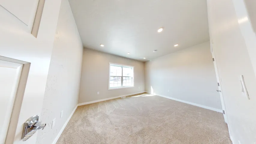 Empty room featuring light carpet and recessed lighting