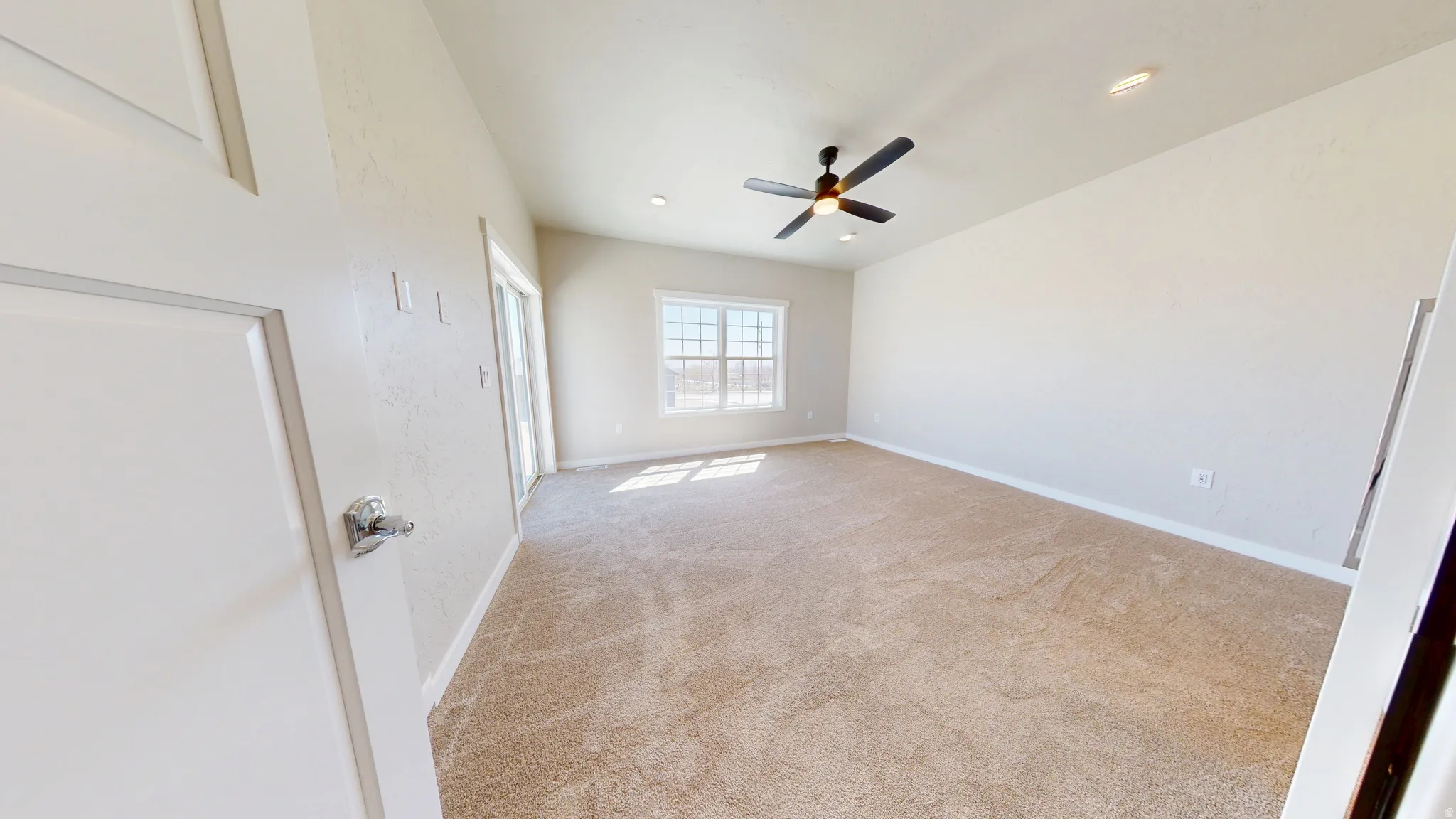 Unfurnished bedroom featuring light colored carpet, ceiling fan, and recessed lighting