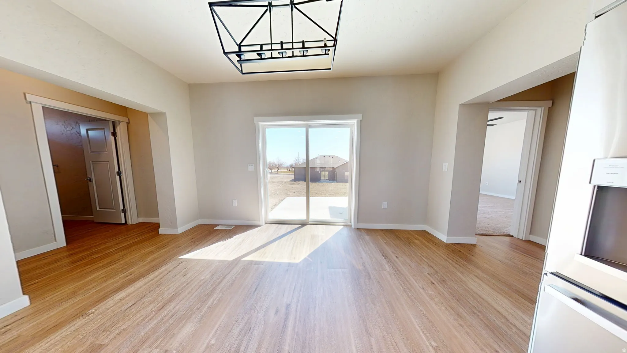 Unfurnished dining area with light wood-type flooring and baseboards