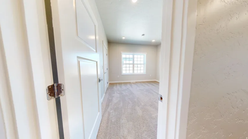 Hall featuring light carpet and recessed lighting