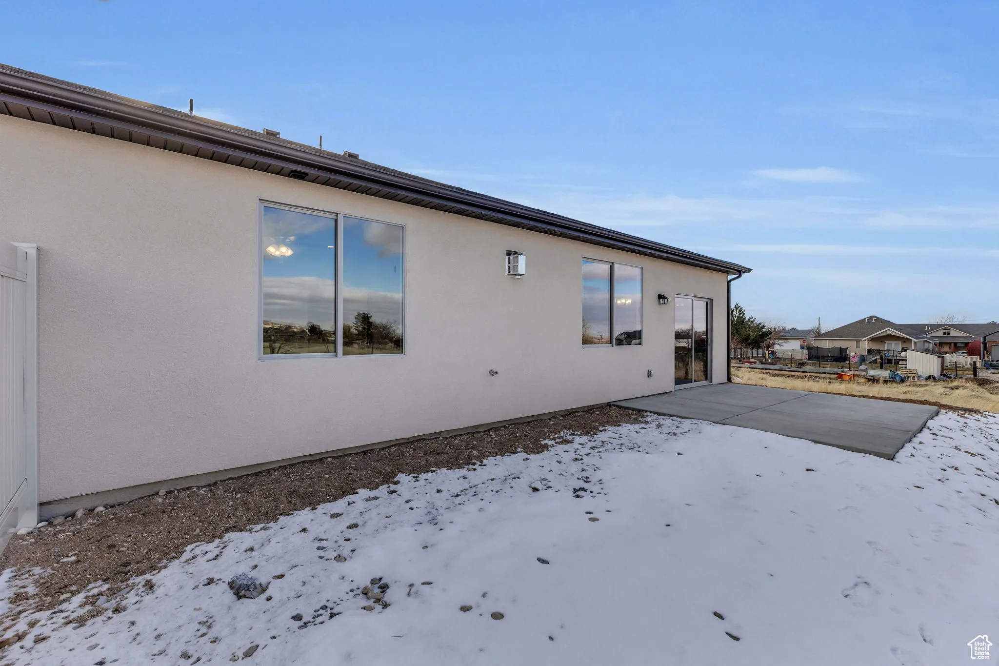 View of snow covered exterior featuring a patio