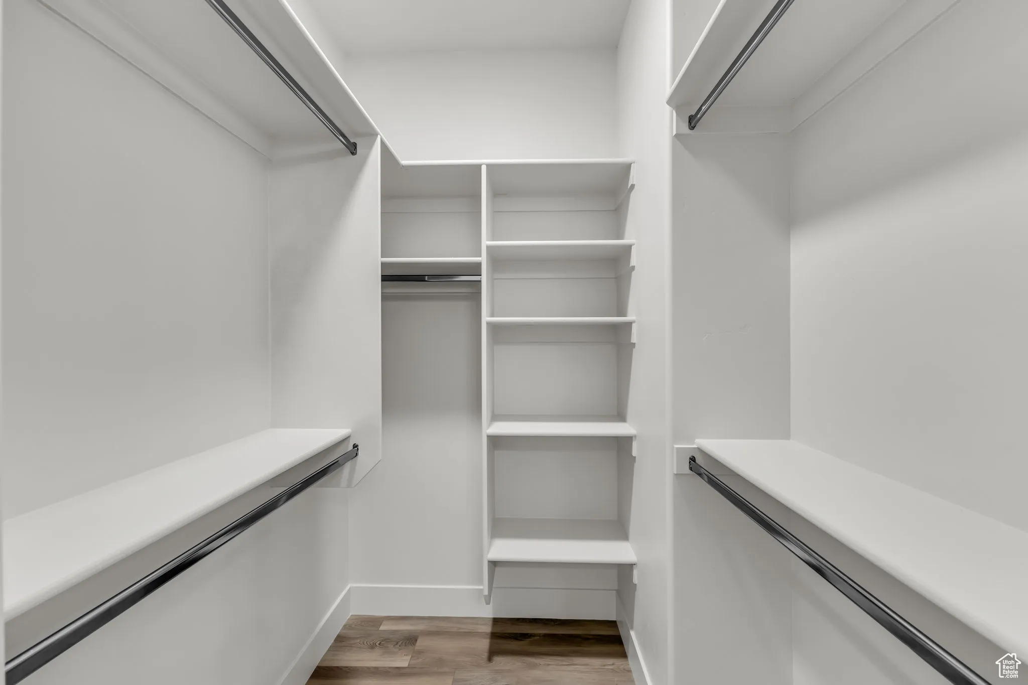 Spacious closet with hardwood / wood-style floors