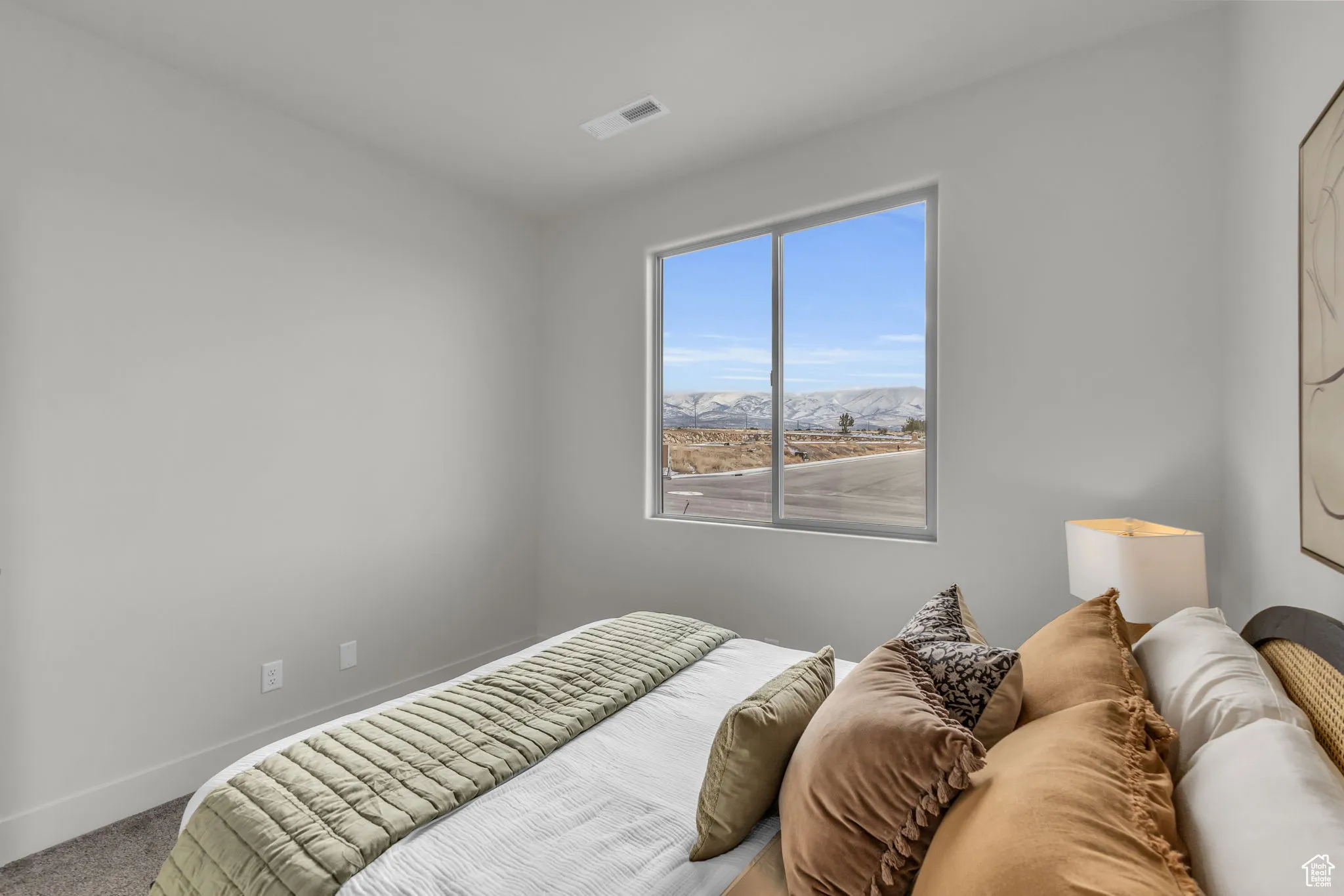 Carpeted bedroom with a mountain view