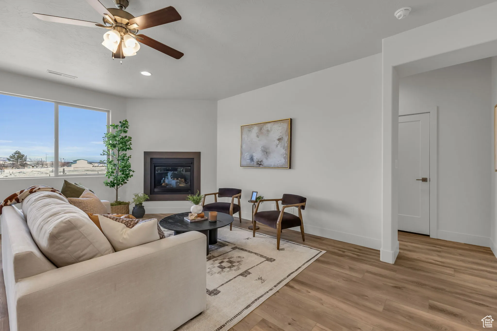 Living room featuring light hardwood / wood-style flooring and ceiling fan
