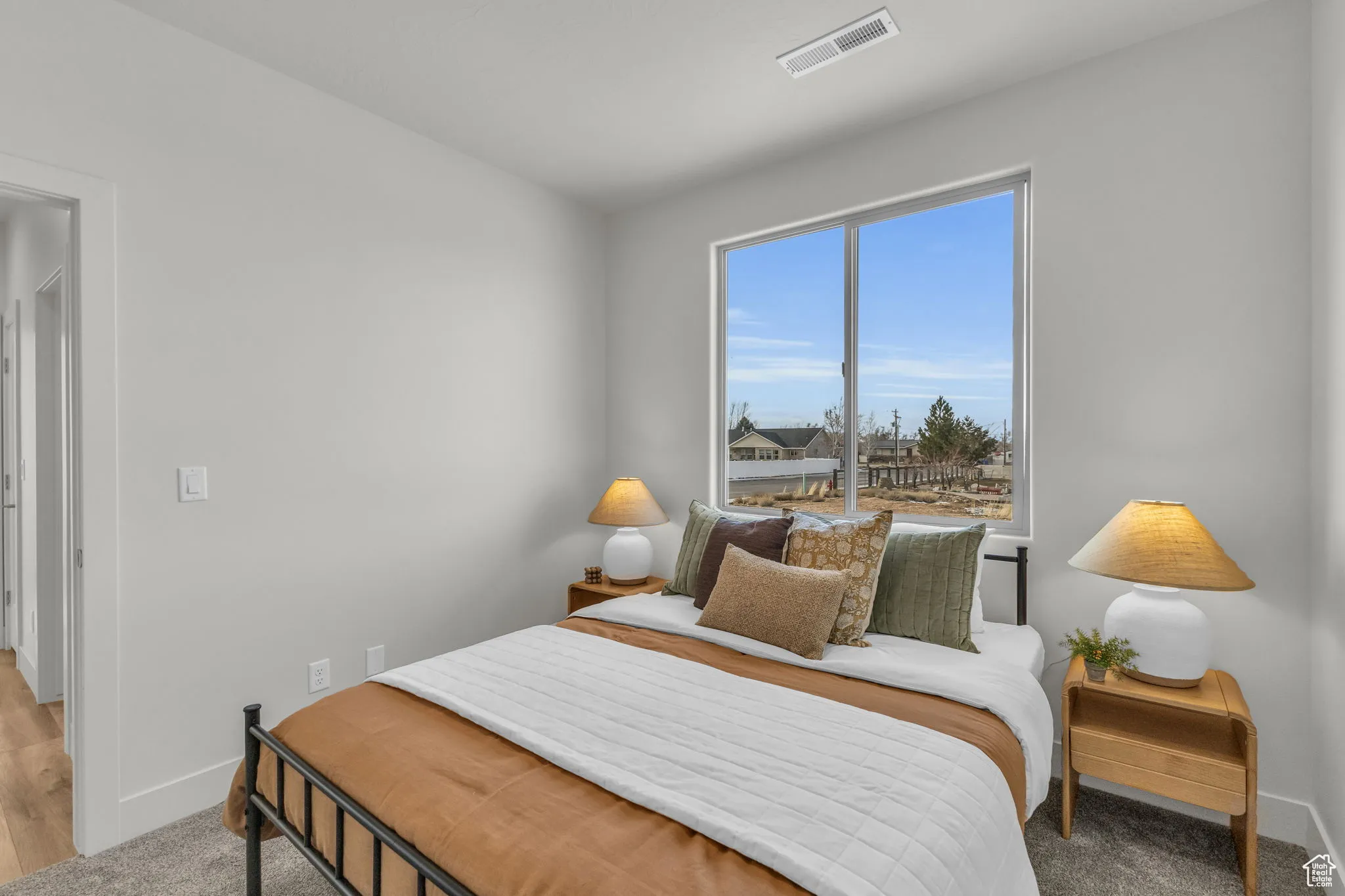 Bedroom featuring light carpet