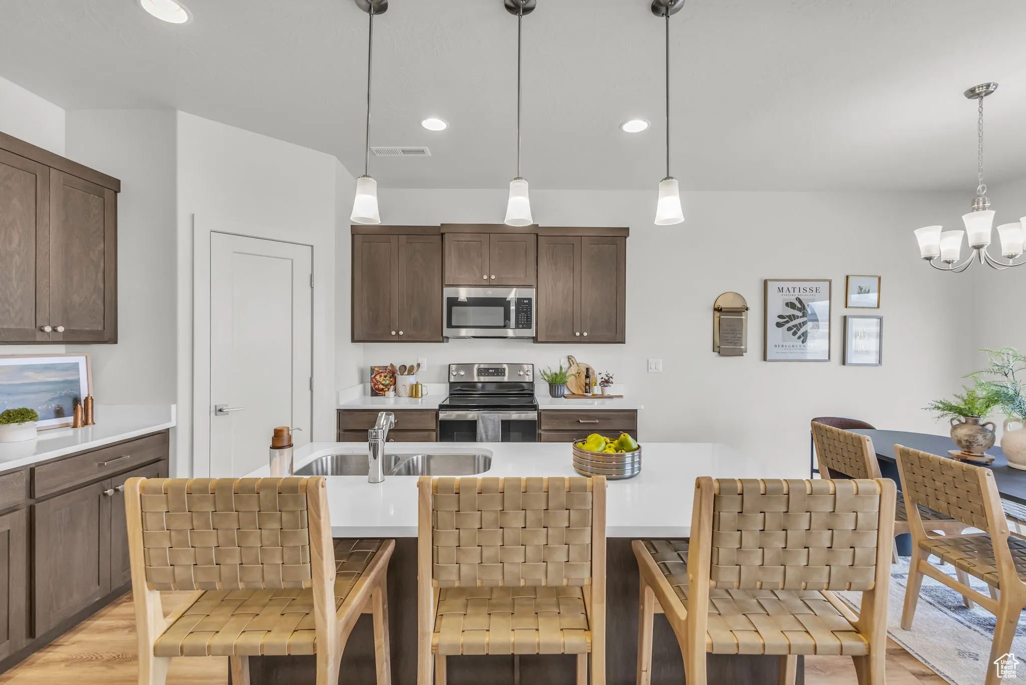 Kitchen with pendant lighting, stainless steel appliances, and a breakfast bar area