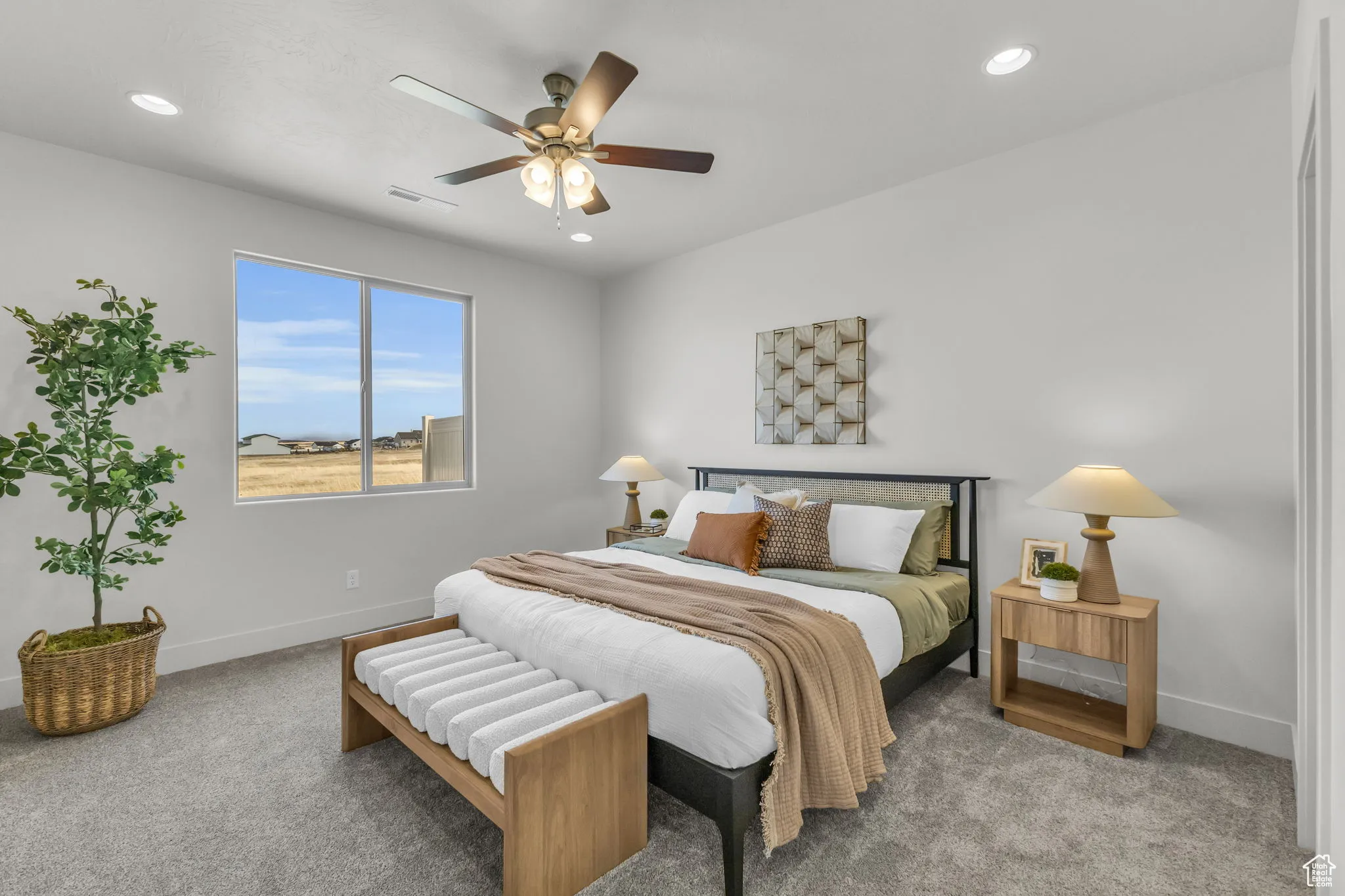 Carpeted bedroom featuring ceiling fan