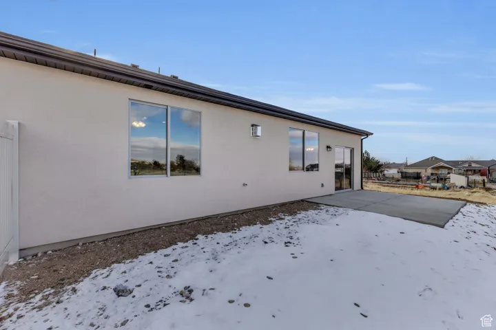 Snow covered property featuring a patio