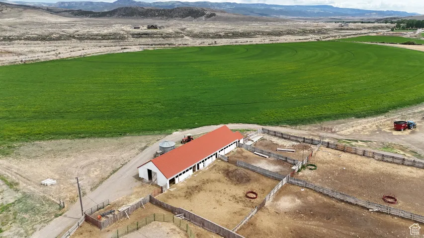 Drone / aerial view of a mountainous background and a golf club