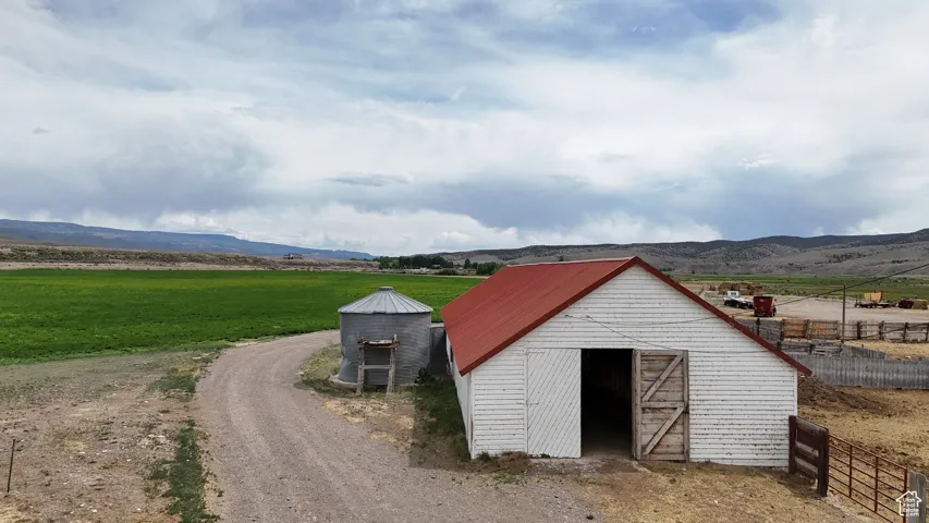 View of barn featuring a view of rural / pastoral area and a mountain view