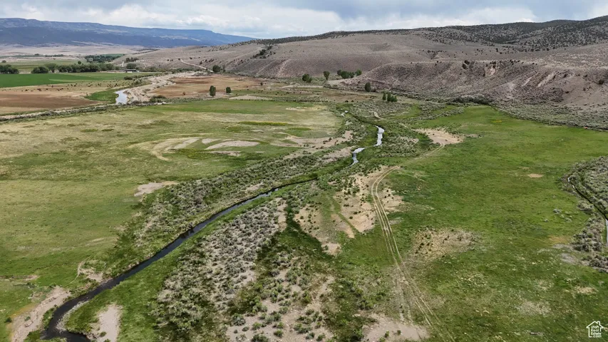 Aerial view of property's location with a mountainous background and rural landscape