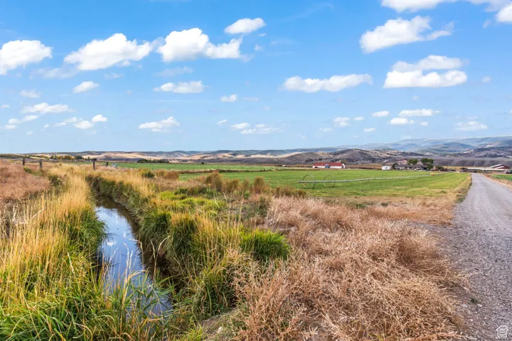 View of mountain feature with a rural view and a water view