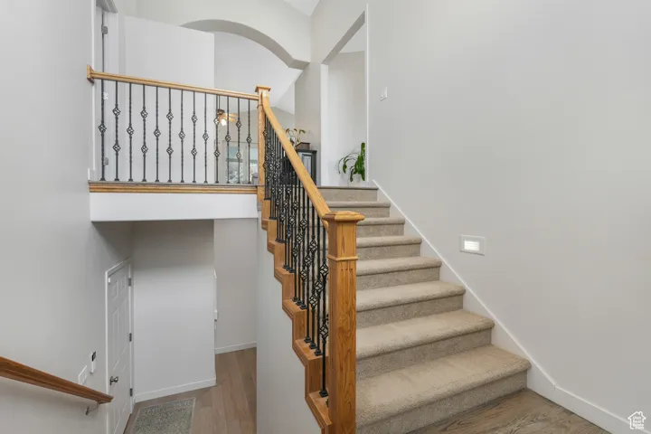 Stairway featuring hardwood / wood-style floors